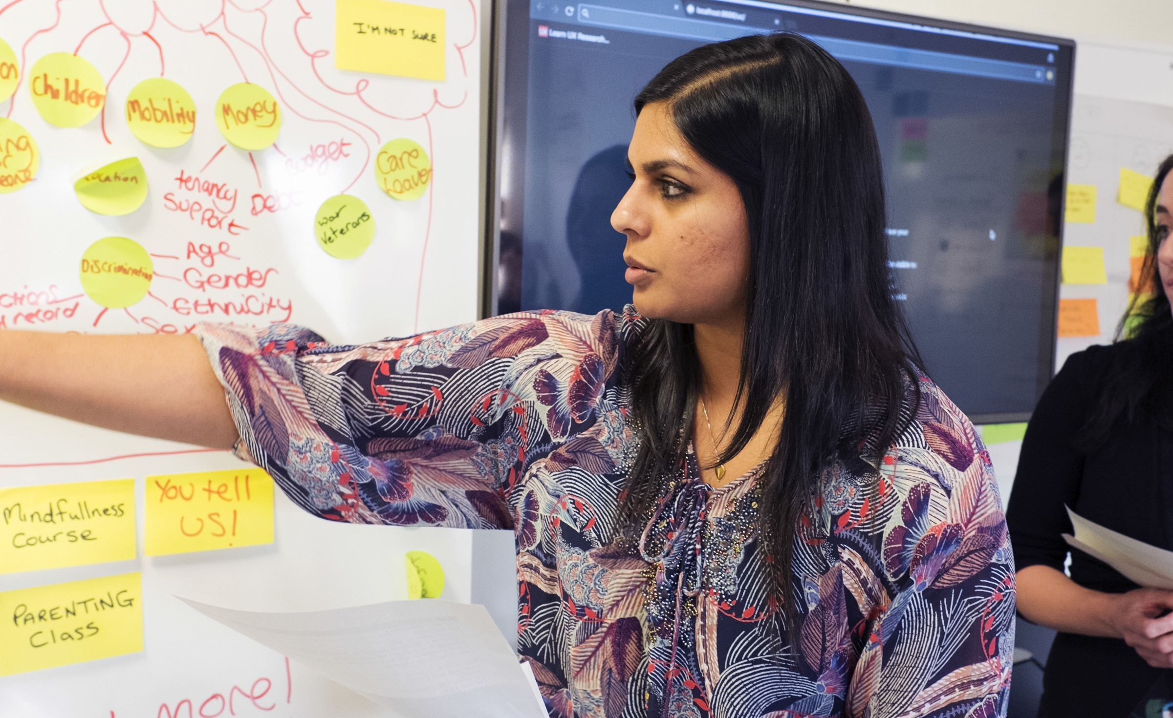 Woman pointing at whiteboard