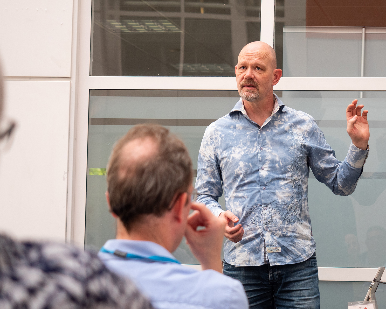 Pieter standing in front of an audience, delivering a presentation