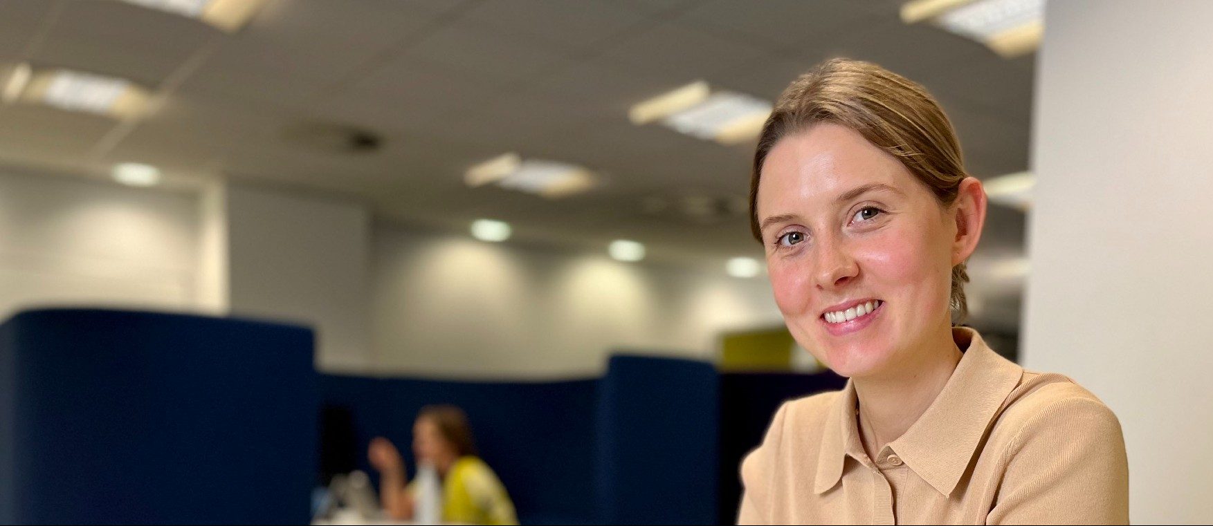 A woman smiling in a DWP office